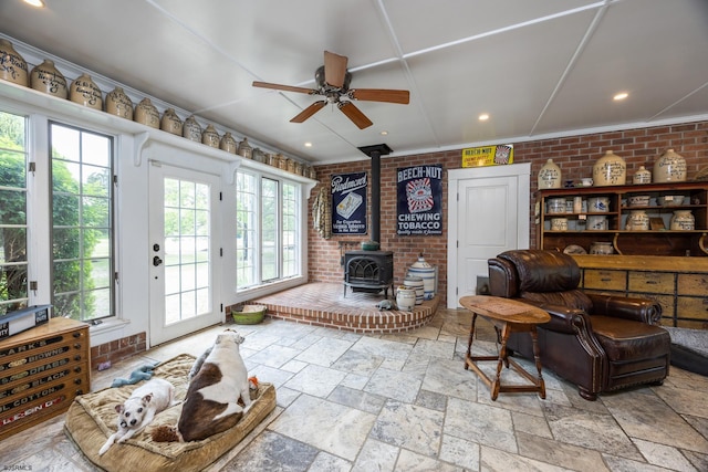 3065 N Rte 9, Ocean View, NJ 08230 - living area featuring a wood stove, ceiling fan, brick wall, stone tile floors, and recessed lighting