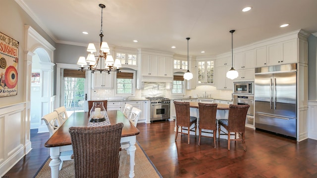 8904 Ventnor Ave, Margate, NJ 08402 - dining space featuring a chandelier, dark wood-style floors, crown molding, recessed lighting, and a decorative wall