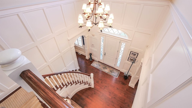 8904 Ventnor Ave, Margate, NJ 08402 - entryway featuring a decorative wall, a chandelier, dark wood finished floors, and arched walkways