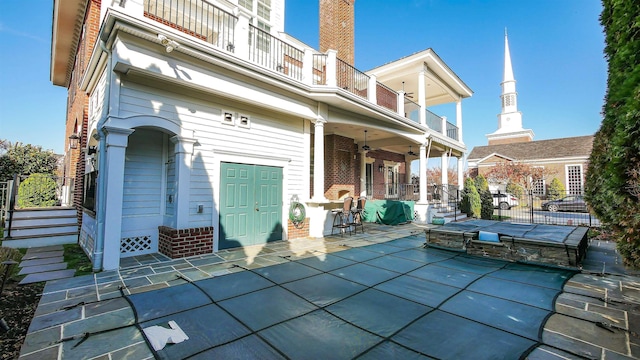 8904 Ventnor Ave, Margate, NJ 08402 - back of property featuring a balcony, a patio area, brick siding, and a ceiling fan