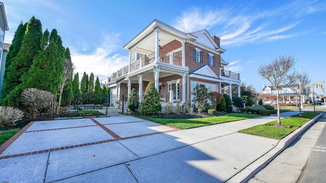 8904 Ventnor Ave, Margate, NJ 08402 - view of front facade featuring a balcony, brick siding, a chimney, and a gate