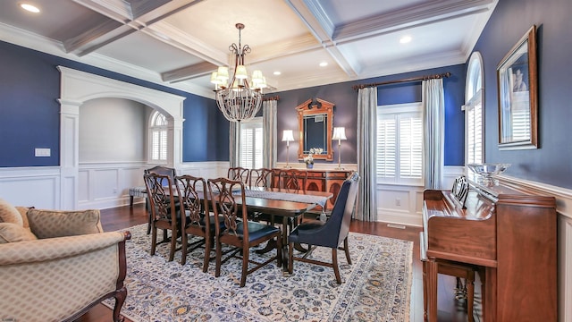 8904 Ventnor Ave, Margate, NJ 08402 - dining space with beam ceiling, a chandelier, wood finished floors, a wainscoted wall, and coffered ceiling