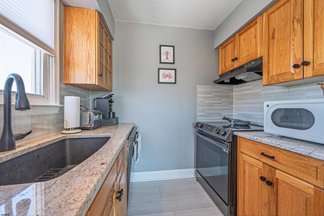 3 Schooner Cv Unit B, Brigantine, NJ 08203 - kitchen featuring black range with electric cooktop, a sink, under cabinet range hood, and tasteful backsplash