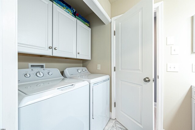 3 Schooner Cv Unit B, Brigantine, NJ 08203 - washroom featuring separate washer and dryer, light marble finish flooring, and cabinet space