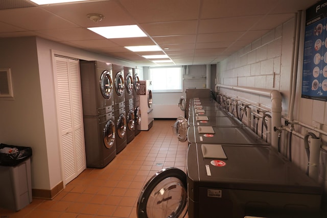 6101 Monmouth Ave Unit 201, Ventnor, NJ 08406 - community laundry room featuring stacked washer and clothes dryer, light tile patterned flooring, baseboards, and separate washer and dryer