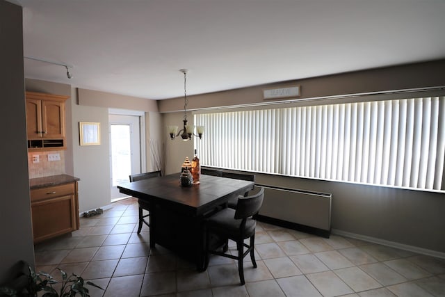 6101 Monmouth Ave Unit 201, Ventnor, NJ 08406 - dining space featuring a chandelier, light tile patterned flooring, rail lighting, and baseboards