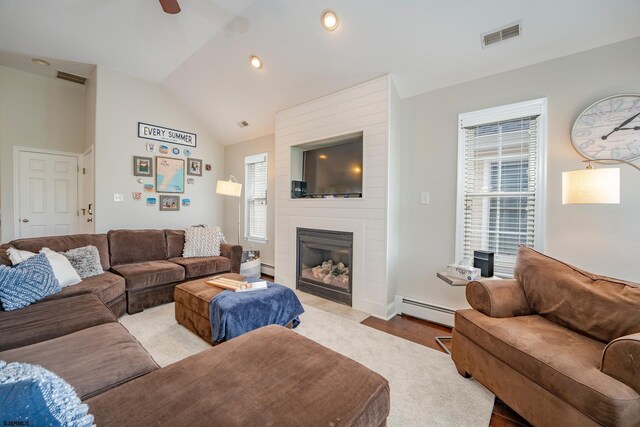 1525 Asbury Ave Unit B, Ocean City, NJ 08226 - living area with a baseboard heating unit, a large fireplace, vaulted ceiling, a ceiling fan, and wood finished floors