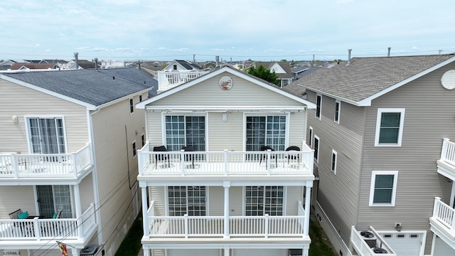 1525 Asbury Ave Unit B, Ocean City, NJ 08226 - back of house featuring a balcony, a residential view, and a garage