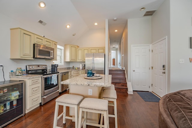 1525 Asbury Ave Unit B, Ocean City, NJ 08226 - kitchen with cream cabinets, stainless steel appliances, wine cooler, a kitchen breakfast bar, and a center island