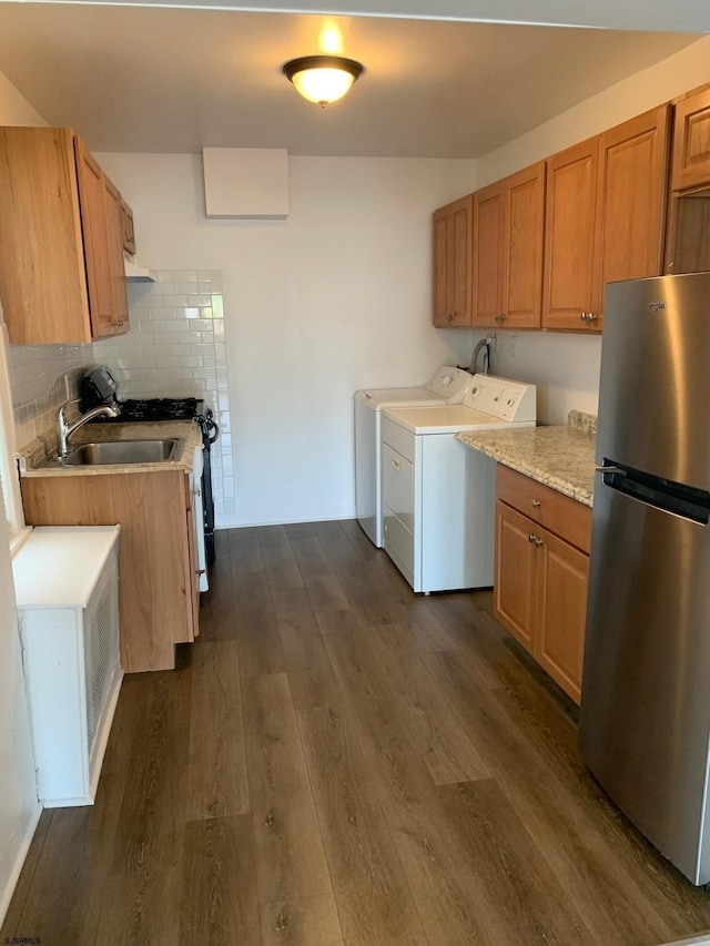 212 N Suffolk Ave, Ventnor Heights, NJ 08406 - kitchen featuring freestanding refrigerator, washing machine and dryer, dark wood-style floors, light countertops, and under cabinet range hood