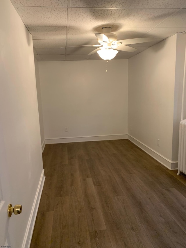 212 N Suffolk Ave, Ventnor Heights, NJ 08406 - unfurnished room with a paneled ceiling, dark wood-type flooring, ceiling fan, baseboards, and radiator heating unit