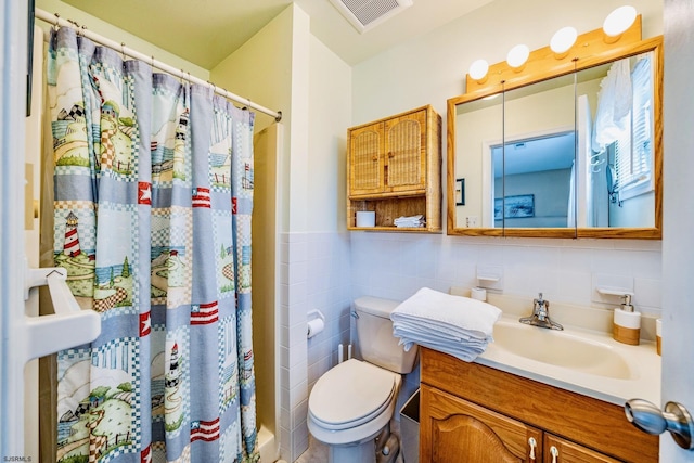 18 E 14th St Unit 2, Ocean City, NJ 08226 - bathroom with tile walls, toilet, vanity, curtained shower, and a wainscoted wall