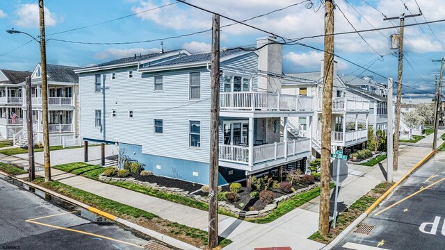 18 E 14th St Unit 2, Ocean City, NJ 08226 - view of property exterior with uncovered parking and a chimney