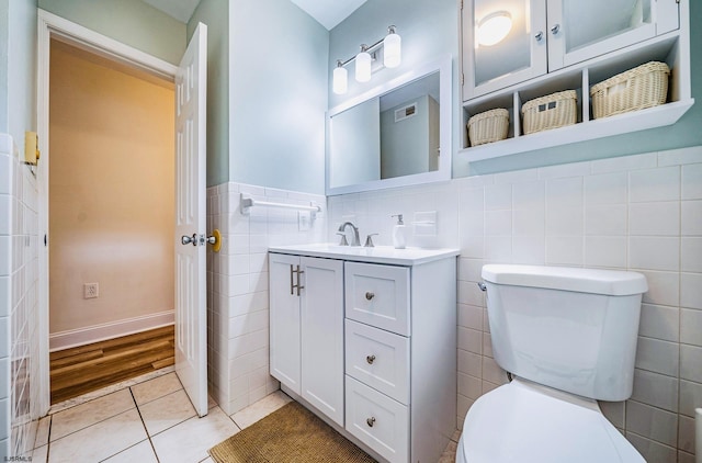 16 E 14th St Unit 1, Ocean City, NJ 08226 - bathroom featuring tile walls, vanity, toilet, tile patterned flooring, and a wainscoted wall
