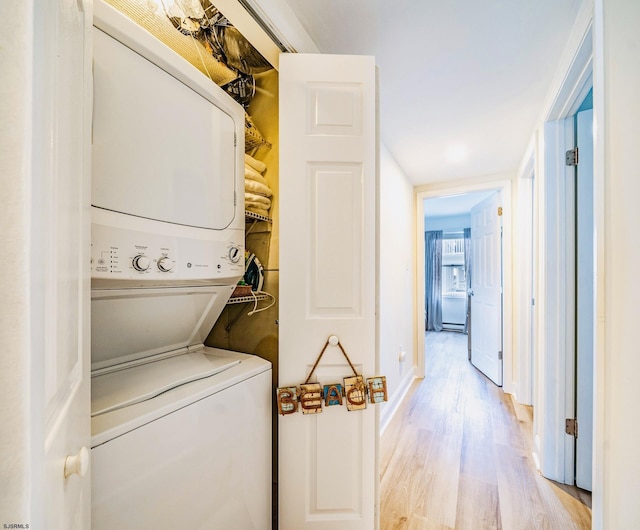 16 E 14th St Unit 1, Ocean City, NJ 08226 - laundry area featuring stacked washer and clothes dryer, light wood finished floors, and baseboards