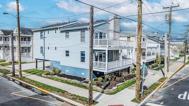 16 E 14th St Unit 1, Ocean City, NJ 08226 - view of property exterior with uncovered parking and a chimney