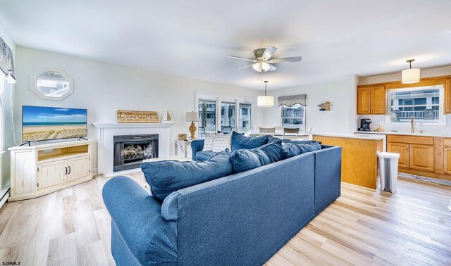 16 E 14th St Unit 1, Ocean City, NJ 08226 - living area with ceiling fan, light wood-style flooring, and a fireplace