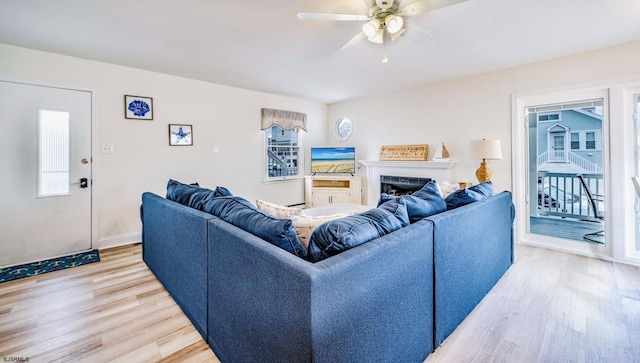 16 E 14th St Unit 1, Ocean City, NJ 08226 - living room featuring light wood finished floors, ceiling fan, healthy amount of natural light, and a fireplace