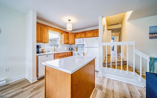 16 E 14th St Unit 1, Ocean City, NJ 08226 - kitchen featuring white appliances, light wood-style flooring, light countertops, and a center island