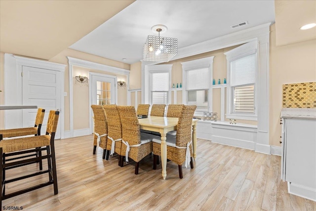 7 N Surrey Ave, Ventnor, NJ 08406 - dining area featuring light wood finished floors, healthy amount of natural light, a chandelier, crown molding, and baseboards