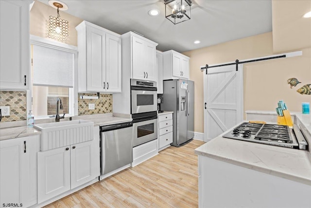 7 N Surrey Ave, Ventnor, NJ 08406 - kitchen featuring appliances with stainless steel finishes, a sink, white cabinets, backsplash, and recessed lighting