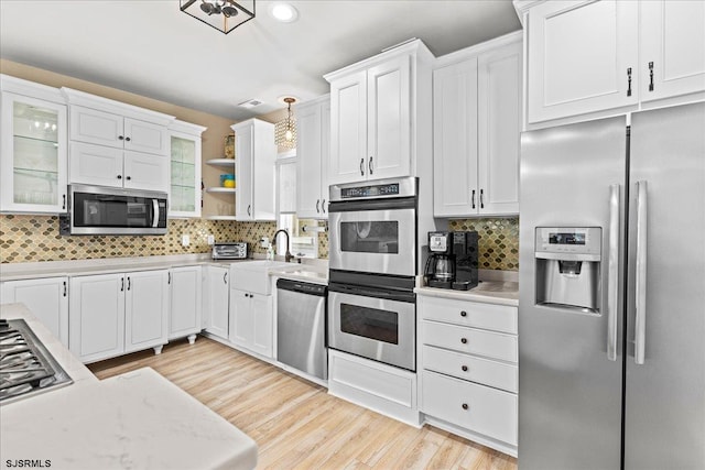 7 N Surrey Ave, Ventnor, NJ 08406 - kitchen with stainless steel appliances, a sink, tasteful backsplash, white cabinetry, and recessed lighting