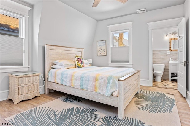 7 N Surrey Ave, Ventnor, NJ 08406 - bedroom with light wood finished floors, ensuite bath, a ceiling fan, and baseboards