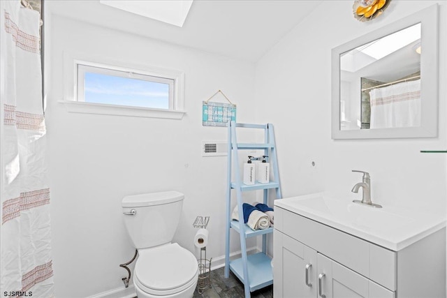 7 N Surrey Ave, Ventnor, NJ 08406 - bathroom featuring vanity, baseboards, toilet, and a skylight