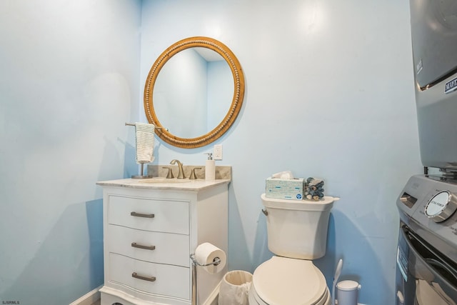 402 Harbour Cv Unit 402, Somers Point, NJ 08244 - bathroom featuring toilet, baseboards, vanity, and estacked washer and dryer