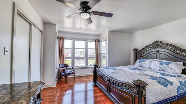 332 N Massachusetts Ave, Atlantic City, NJ 08401 - bedroom with dark wood-style flooring, baseboards, a closet, and ceiling fan