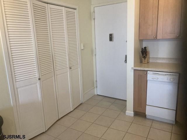 2721 Boardwalk Unit 711, Atlantic City, NJ 08401 - kitchen featuring dishwasher, light tile patterned floors, and light countertops