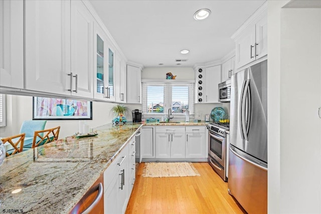 11 S Adams Ave Unit 8, Margate, NJ 08402 - kitchen with stainless steel appliances, white cabinets, a sink, light wood finished floors, and recessed lighting