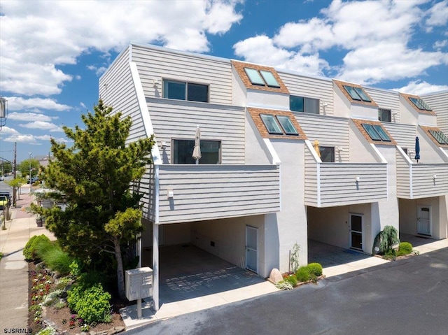 11 S Adams Ave Unit 8, Margate, NJ 08402 - view of front of home with stucco siding and a carport