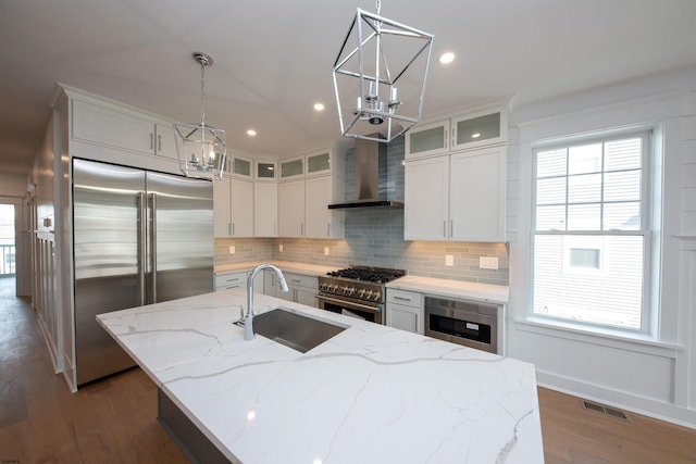 632A Ocean Ave Unit 1, Ocean City, NJ 08226 - kitchen featuring high quality appliances, a sink, wall chimney exhaust hood, a chandelier, and tasteful backsplash
