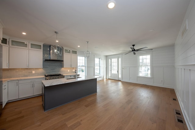 632A Ocean Ave Unit 1, Ocean City, NJ 08226 - kitchen featuring wall chimney exhaust hood, a sink, decorative backsplash, ceiling fan, and pendant lighting