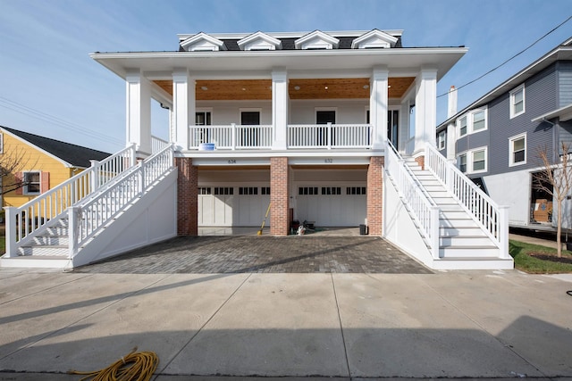 632B Ocean Ave Unit 2, Ocean City, NJ 08226 - view of front of house with stairs, covered porch, driveway, an attached garage, and brick siding