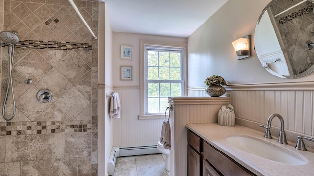 1607 Somers Point Rd, Egg Harbor Township, NJ 08234 - bathroom featuring a wainscoted wall, tiled shower, vanity, baseboard heating, and a decorative wall