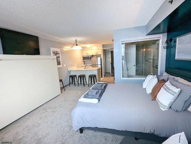 1515 Boardwalk Unit 1708, Atlantic City, NJ 08401 - bedroom with light carpet, a textured ceiling, freestanding refrigerator, and a sink