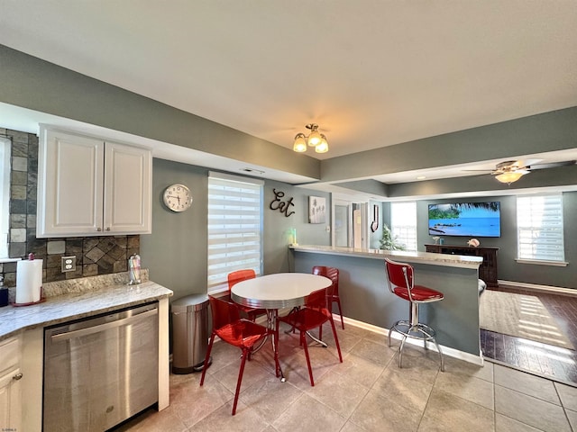 243 Churchill Dr, Egg Harbor Township, NJ 08234 - kitchen with plenty of natural light, decorative backsplash, light tile patterned flooring, and white cabinets