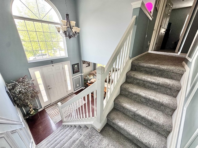 243 Churchill Dr, Egg Harbor Township, NJ 08234 - foyer with stairway, a high ceiling, a chandelier, and carpet