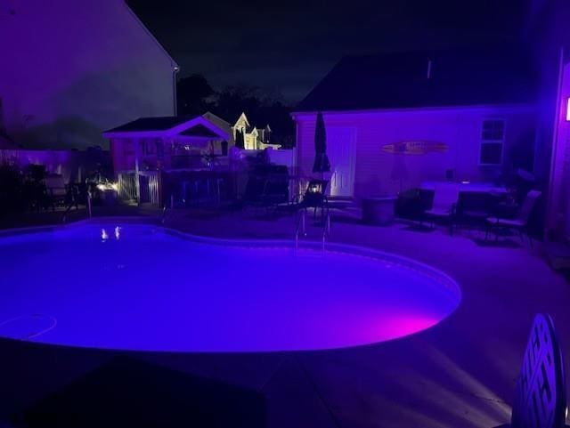243 Churchill Dr, Egg Harbor Township, NJ 08234 - pool at night with a patio and an outdoor pool
