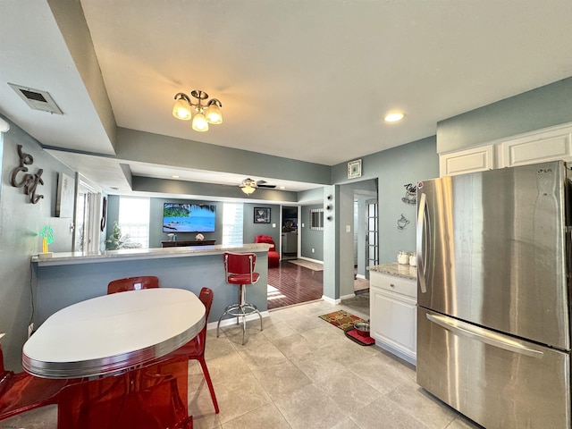 243 Churchill Dr, Egg Harbor Township, NJ 08234 - kitchen featuring freestanding refrigerator, white cabinets, light countertops, baseboards, and light tile patterned floors