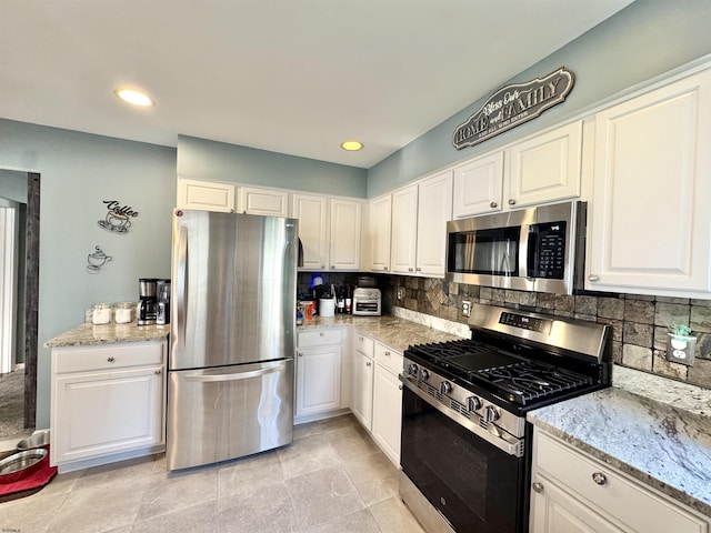 243 Churchill Dr, Egg Harbor Township, NJ 08234 - kitchen with appliances with stainless steel finishes, decorative backsplash, white cabinets, light stone countertops, and recessed lighting
