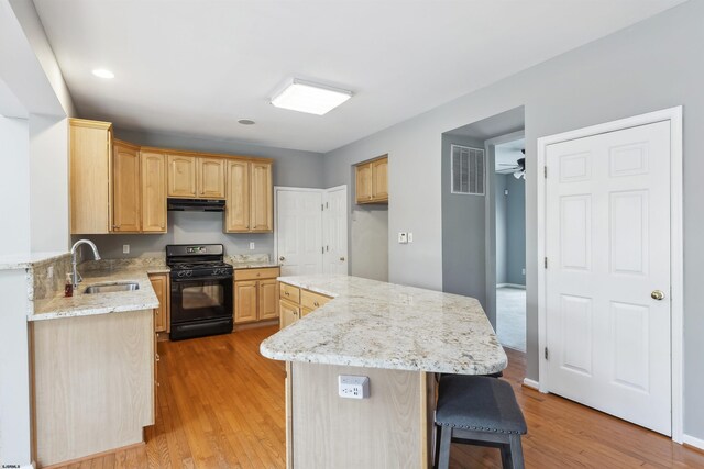 15 Gallant Fox Ln, Egg Harbor Township, NJ 08234 - kitchen with gas stove, a sink, ventilation hood, light brown cabinets, and light wood-type flooring