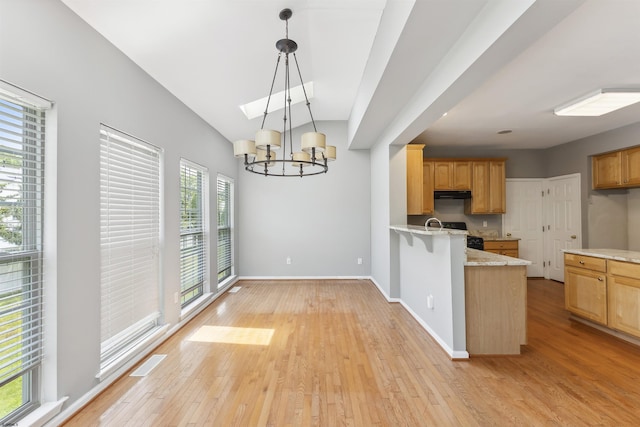 15 Gallant Fox Ln, Egg Harbor Township, NJ 08234 - kitchen featuring a chandelier, under cabinet range hood, light wood-style flooring, a peninsula, and baseboards
