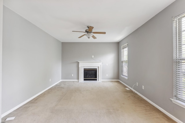 15 Gallant Fox Ln, Egg Harbor Township, NJ 08234 - unfurnished living room with a fireplace with flush hearth, a ceiling fan, baseboards, and light colored carpet
