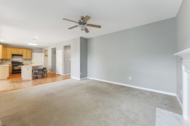 15 Gallant Fox Ln, Egg Harbor Township, NJ 08234 - unfurnished living room with a ceiling fan, baseboards, light carpet, and a fireplace