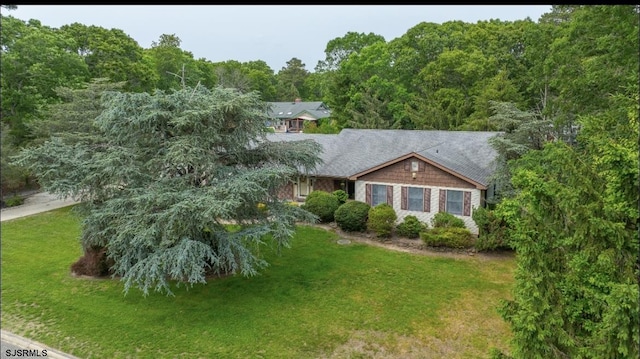 5 Edward Ter, Upper Township, NJ 08230 - view of front of home with a front yard, a wooded view, and a shingled roof