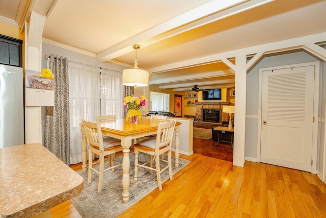 5 Edward Ter, Upper Township, NJ 08230 - dining area with a fireplace, light wood-style flooring, ceiling fan, beam ceiling, and crown molding