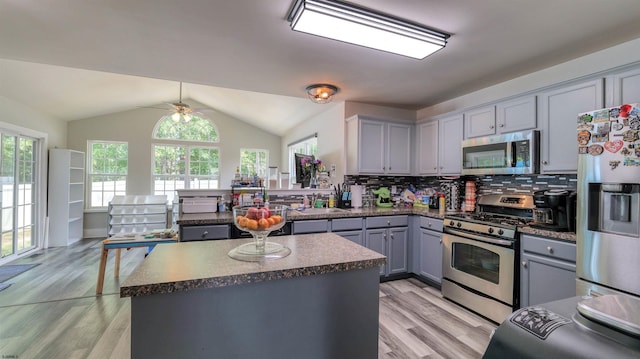 206 Branch Hill Dr, Egg Harbor Township, NJ 08234 - kitchen featuring stainless steel appliances, gray cabinets, dark countertops, light wood-style floors, and vaulted ceiling